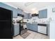 Well-equipped kitchen featuring stainless steel appliances, stylish grey cabinets, and a functional layout at 3647 Minute Maid Ramp Rd 1 Rd, Davenport, FL 33837