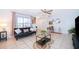 Inviting living room with tile flooring, comfortable seating, a ceiling fan, and abundant natural light at 3647 Minute Maid Ramp Rd 1 Rd, Davenport, FL 33837