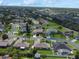 Aerial view of a residential neighborhood featuring manicured lawns and mature trees at 3811 Gator Bay Ln, St Cloud, FL 34772