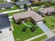 Aerial view of a home featuring mature landscaping, a driveway, and a two-car garage at 3811 Gator Bay Ln, St Cloud, FL 34772