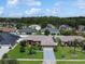 An aerial view of the home nestled within a lush neighborhood with mature trees at 3811 Gator Bay Ln, St Cloud, FL 34772
