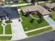 An aerial view of a single-story home with a well-maintained lawn and neighborhood setting at 3811 Gator Bay Ln, St Cloud, FL 34772