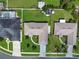 An aerial view shows neighboring homes with fenced yards and manicured green lawns at 3811 Gator Bay Ln, St Cloud, FL 34772