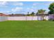 Backyard with a white vinyl fence and lush green grass at 3811 Gator Bay Ln, St Cloud, FL 34772