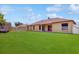 Large backyard with lush green grass and a view of the home at 3811 Gator Bay Ln, St Cloud, FL 34772