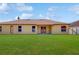 The back of the house has a beautiful, large yard with windows and doors at 3811 Gator Bay Ln, St Cloud, FL 34772