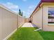 A view of the home's backyard features a well-maintained lawn and privacy fence at 3811 Gator Bay Ln, St Cloud, FL 34772