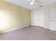 This bedroom includes tile floors, neutral walls, a ceiling fan, and a large closet at 3811 Gator Bay Ln, St Cloud, FL 34772