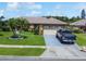 Charming single-story home featuring a two-car garage, a well-manicured lawn, and a paved driveway with a parked pickup truck at 3811 Gator Bay Ln, St Cloud, FL 34772