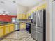 Bright kitchen featuring stainless steel appliances and yellow cabinetry at 3811 Gator Bay Ln, St Cloud, FL 34772