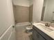 Bathroom features modern fixtures, a tub, and shower with tile surround at 4053 Redbridge Loop, Davenport, FL 33837