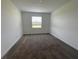 Bedroom featuring a window, neutral carpet, and white walls at 4053 Redbridge Loop, Davenport, FL 33837