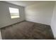 Empty bedroom with plush carpet and natural light from the window at 4053 Redbridge Loop, Davenport, FL 33837