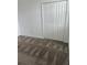 Bedroom featuring a neutral carpet, window, closet with bi-fold doors, and white walls at 4053 Redbridge Loop, Davenport, FL 33837