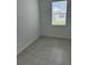 Small bedroom featuring tiled flooring, neutral paint and window at 4053 Redbridge Loop, Davenport, FL 33837