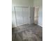 Bedroom showcasing a closet with white bi-fold doors and neutral carpet at 4053 Redbridge Loop, Davenport, FL 33837