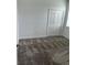 Bedroom featuring a neutral carpet, window with blinds, and closet with bi-fold doors at 4053 Redbridge Loop, Davenport, FL 33837
