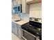 Modern kitchen features stainless steel appliances and elegant light countertops at 4053 Redbridge Loop, Davenport, FL 33837
