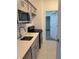 Contemporary kitchen with stainless steel appliances and an open view to the bedroom at 4053 Redbridge Loop, Davenport, FL 33837