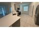 Bright kitchen featuring stainless steel appliances, gray cabinets, tiled floor and white countertop at 4053 Redbridge Loop, Davenport, FL 33837