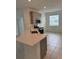 Cozy kitchen featuring stainless steel appliances, gray cabinets, tiled floor and eat in area at 4053 Redbridge Loop, Davenport, FL 33837