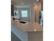 Open concept kitchen featuring stainless steel appliances, gray cabinets, and white countertops at 4053 Redbridge Loop, Davenport, FL 33837