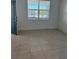 Inviting living room with tile flooring and natural light from a large window at 4053 Redbridge Loop, Davenport, FL 33837