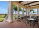 Outdoor patio with tables, chairs and views of the golf course at 4053 Redbridge Loop, Davenport, FL 33837