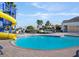 Fun pool area with a slide, lounge chairs, and a splash pool at 4053 Redbridge Loop, Davenport, FL 33837
