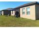 Well maintained backyard features a table, chairs, and umbrella next to the screened in lanai at 409 Conway Ave, St Cloud, FL 34771