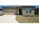 Inviting single-Gathering home with a well-maintained lawn, convenient driveway, and an attached two-car garage at 409 Conway Ave, St Cloud, FL 34771