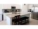 Modern kitchen featuring white cabinets, granite countertops, stainless steel appliances, and an island with seating at 409 Conway Ave, St Cloud, FL 34771