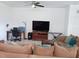 Spacious living room featuring a large television, comfortable seating, and a dedicated workspace for productivity at 409 Conway Ave, St Cloud, FL 34771
