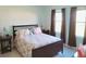 Comfortable bedroom featuring ample natural light from the windows, neutral walls, and cozy furnishings at 409 Conway Ave, St Cloud, FL 34771