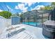 Backyard featuring a screened pool, shed, and lounge chairs, providing a relaxing outdoor space at 435 Pennsylvania Ave, St Cloud, FL 34769