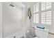Clean bathroom featuring a shower and a shuttered window at 435 Pennsylvania Ave, St Cloud, FL 34769