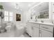Well-lit bathroom with elegant chandelier and a built-in tub at 435 Pennsylvania Ave, St Cloud, FL 34769
