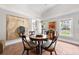 Bright dining room featuring a round table, tile floors, and large art pieces at 435 Pennsylvania Ave, St Cloud, FL 34769