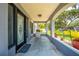 Cozy front porch, featuring decorative columns, a welcoming chair, and intricate door design at 435 Pennsylvania Ave, St Cloud, FL 34769