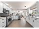 Bright kitchen with stainless steel appliances, granite countertops, and white cabinets at 435 Pennsylvania Ave, St Cloud, FL 34769