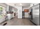 Well-lit kitchen featuring white cabinetry, stainless steel appliances, and modern design elements at 435 Pennsylvania Ave, St Cloud, FL 34769