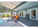 View of the screened-in patio with furniture, offering a comfortable outdoor living space by the pool at 435 Pennsylvania Ave, St Cloud, FL 34769
