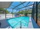 Inviting pool with an enclosing screen, featuring a shed and lounge chairs for relaxation and leisure at 435 Pennsylvania Ave, St Cloud, FL 34769