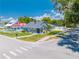 Charming grey home with manicured lawn and inviting front porch on a sunny street corner at 435 Pennsylvania Ave, St Cloud, FL 34769