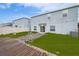 Backyard with wooden deck, stone landscaping, grass, and a view of the home's exterior at 454 Hamlet Loop, Davenport, FL 33837