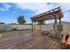 Large backyard with wooden deck, pergola, and ample space for recreation and relaxation at 454 Hamlet Loop, Davenport, FL 33837