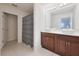 Bathroom featuring double vessel sinks, dark wood vanity, and a tiled floor at 454 Hamlet Loop, Davenport, FL 33837
