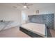 Bright bedroom featuring gray upholstered bed frame, ceiling fan, and neutral carpeting for a cozy feel at 454 Hamlet Loop, Davenport, FL 33837