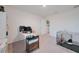 Bright bedroom features neutral carpet, white walls and includes a desk, shelving, and pet crate at 454 Hamlet Loop, Davenport, FL 33837