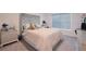 Comfortable bedroom featuring a stylish headboard, plush bedding, and a modern window shade at 454 Hamlet Loop, Davenport, FL 33837